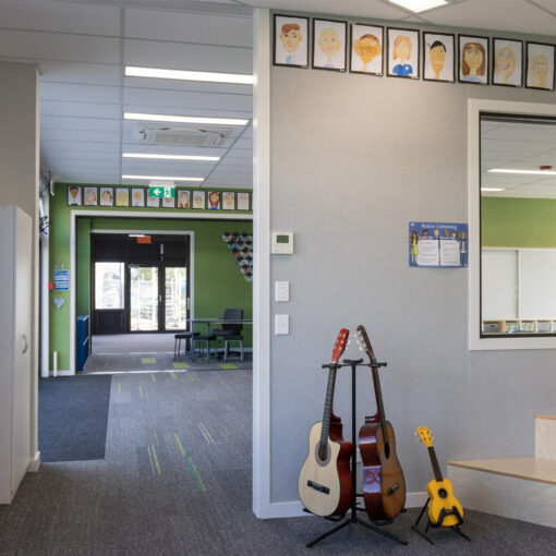 Autex composition acoustic panel on walls in a classroom with guitars in the foreground