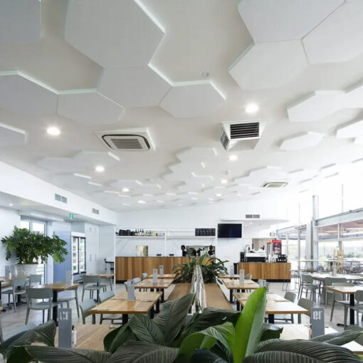 Hexagons of autex quietspace acoustic panels on ceiling in cafe