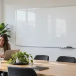 Large wall-mounted whiteboard and charcoal pinboard in a bright Australian meeting room.